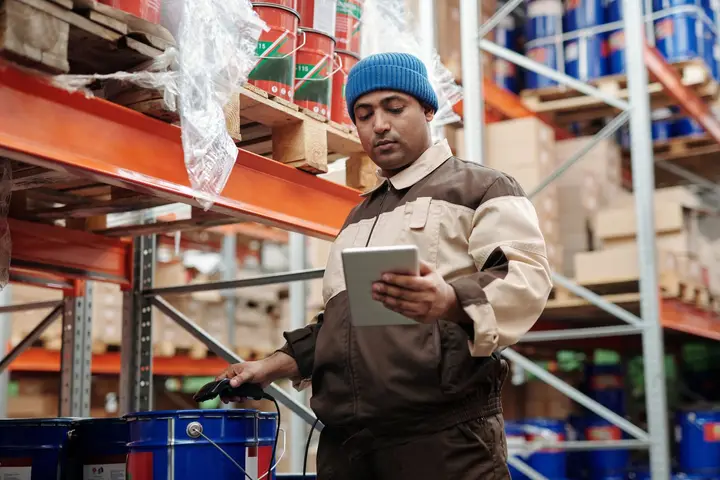 Warehouse worker checking inventory on a tablet (sample photo)